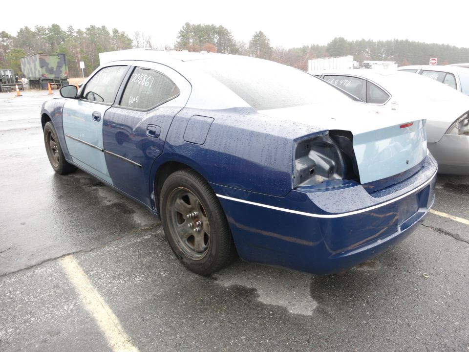 Rear view of a blue and light blue sedan with a missing taillight and two-tone paint