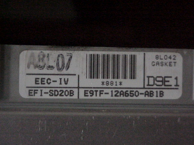 Label on an engine control unit with text EEC-IV, EFI-SD20B, E9TF-12A650-AB1B, and 8L042 GASKET
