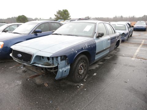 1991 Ford LTD Crown Victoria - This Ford Crown Victoria has been repainted with different colors on its body panels and is missing front-end components.
