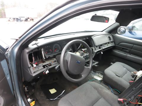 1991 Ford LTD Crown Victoria - The interior of a car shows a disassembled dashboard with exposed wiring and missing panels.
