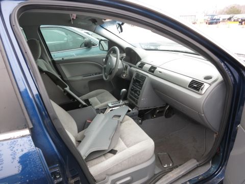 1991 Ford LTD Crown Victoria - The interior of a blue sedan is visible, with another vehicle in the background.