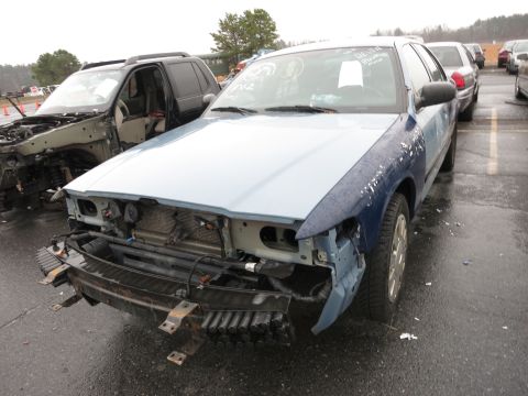 1991 Ford LTD Crown Victoria - This 1991 Ford Crown Victoria LTD is in a junkyard, missing its front bumper and grille.