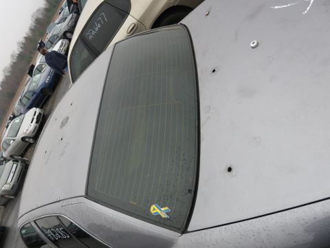 1991 Ford LTD Crown Victoria - This sedan has several bullet holes on its trunk lid. A Swedish ribbon sticker is visible on the rear window.