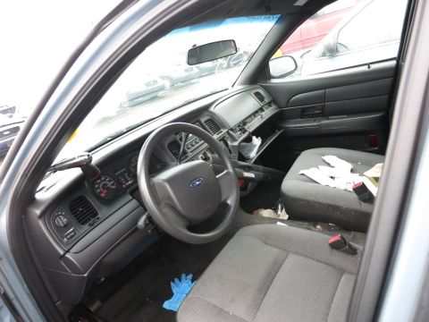 1991 Ford LTD Crown Victoria - The interior of a Ford Crown Victoria shows a messy cabin with an open glove compartment and scattered debris on the seats.