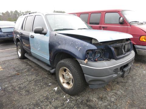 1991 Ford LTD Crown Victoria - This damaged Ford Explorer has a blue front fender and a lighter blue door, with the headlight assembly missing.