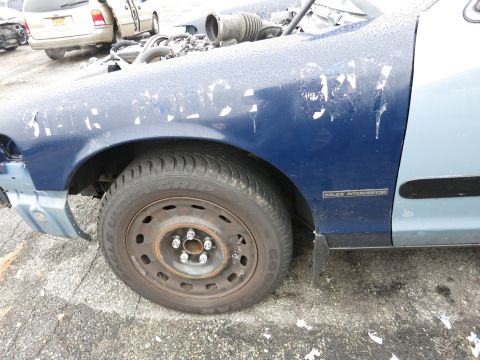 1991 Ford LTD Crown Victoria - Front fender and wheel of a police interceptor, showing some wear and tear.