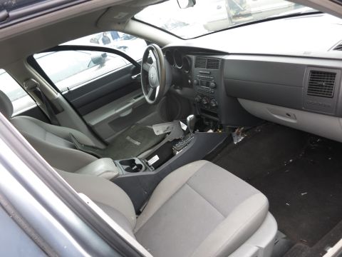 1991 Ford LTD Crown Victoria - The interior of a Dodge Magnum shows wear and tear, with debris scattered on the floor.