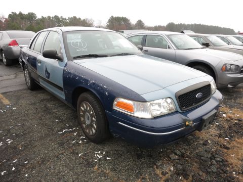 1991 Ford LTD Crown Victoria - This Ford Crown Victoria has a two-tone paint scheme and is parked outdoors with other vehicles.