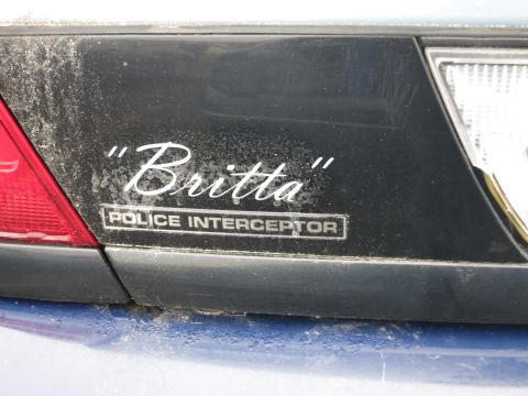 1991 Ford LTD Crown Victoria - Custom badging on the rear of a police vehicle reads "Britta" above "POLICE INTERCEPTOR".