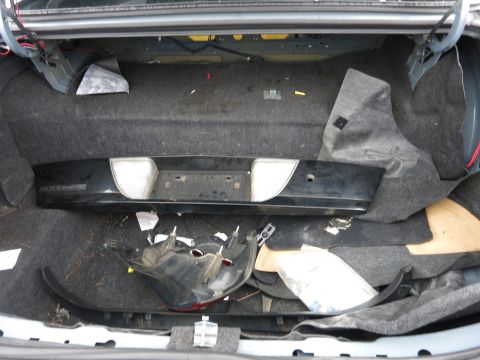 1991 Ford LTD Crown Victoria - Disassembled parts and trim are stored inside a car's trunk.