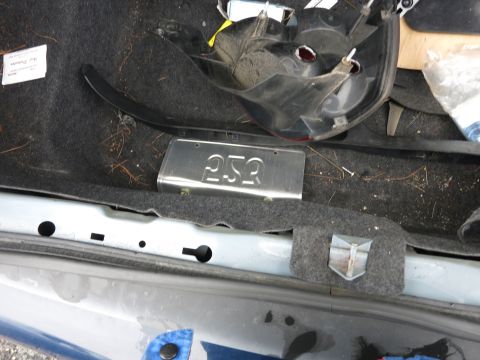 1991 Ford LTD Crown Victoria - Interior view of a car trunk showing disassembled parts and debris.