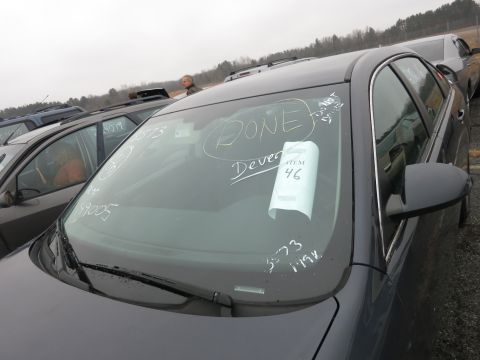 1991 Ford LTD Crown Victoria - A dark sedan sits in a lot with other vehicles, its windshield marked with chalk writing and an item tag.