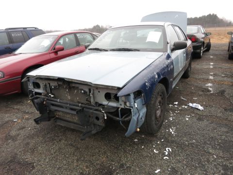 1991 Ford LTD Crown Victoria - A 1991 Ford Crown Victoria LTD is seen from the front with its bumper and grille removed.