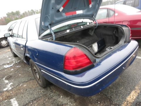 1991 Ford LTD Crown Victoria - Rear view of a blue 1991 Ford Crown Victoria LTD sedan with its trunk open, parked outdoors.