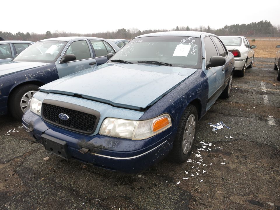 Blue Ford Crown Victoria with hood up, front quarter view