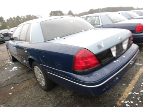 1991 Ford LTD Crown Victoria - A Ford Crown Victoria is parked in a lot with other vehicles visible in the background.