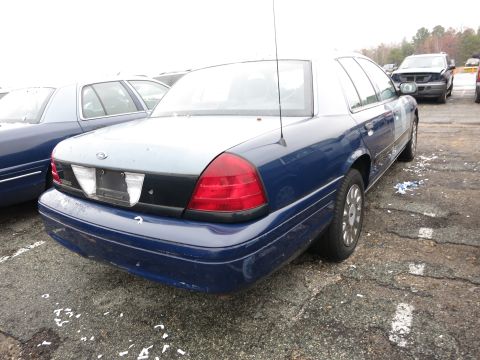 1991 Ford LTD Crown Victoria - The rear of a blue Ford Crown Victoria is shown, parked next to another similar vehicle.