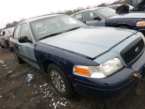 1991 Ford LTD Crown Victoria - A two-tone Ford Crown Victoria sits in a lot with other vehicles.