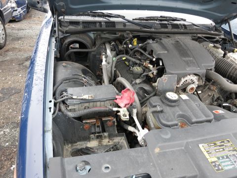 1991 Ford LTD Crown Victoria - Engine bay details of a blue sedan, likely from the early 2000s.