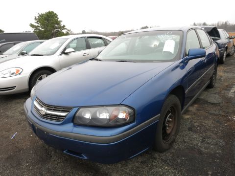 1991 Ford LTD Crown Victoria - Blue sedan parked in a lot with other vehicles.