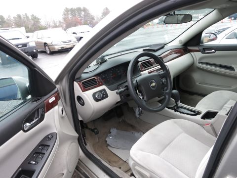 1991 Ford LTD Crown Victoria - Interior view of a car with a Chevrolet emblem on the steering wheel, parked outdoors.
