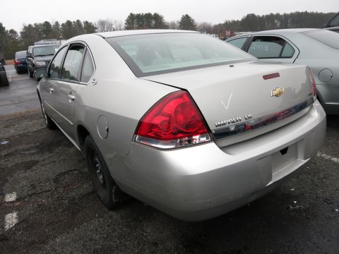1991 Ford LTD Crown Victoria - Rear view of a silver Chevrolet Impala LS, with "IMPALA LS" clearly visible on the trunk lid.