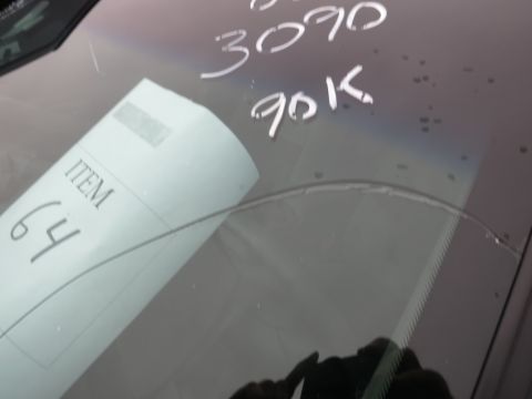 1991 Ford LTD Crown Victoria - A paper tag with 'ITEM 64' is placed on a car's windshield, which has handwritten numbers '3090' and '90K'.