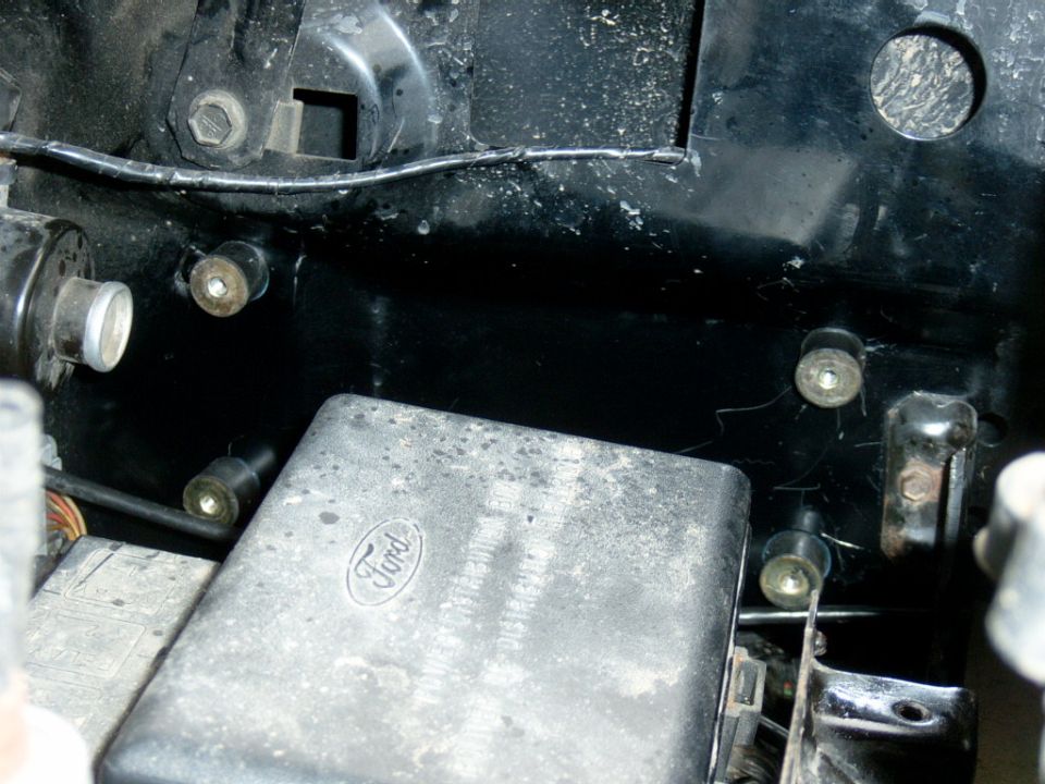 The new home of the ignition, on the driver’s side fender right next to the factory distribution box.  The ignition came with 4 little rubber blocks to mount the unit on to isolate it from vibrations, they have a bolt on one side and a hole on the other for a machine screw, because I was mounting it to the fender I couldn’t fit my hand in to put the nuts on so I drilled hole and tapped them for the rubber things and screwed then on with some Loc-tite.  I had to remove the distribution box, air filter housing, and the coolant/washer fluid tank to fit the drill in.
