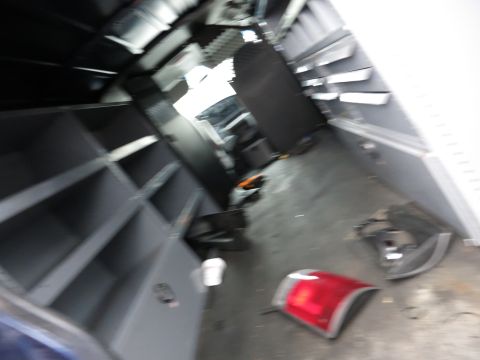 1991 Ford LTD Crown Victoria - The interior of a vehicle, possibly a van or RV, is shown with built-in shelving and loose taillight assemblies on the floor.
