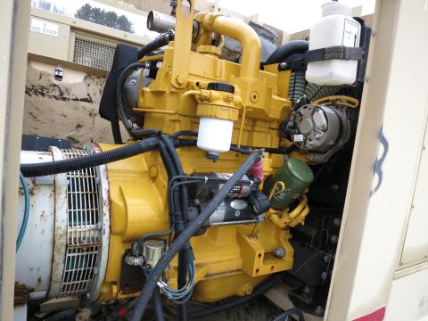 1991 Ford LTD Crown Victoria - A yellow diesel engine is connected to a generator, with various hoses and filters visible.