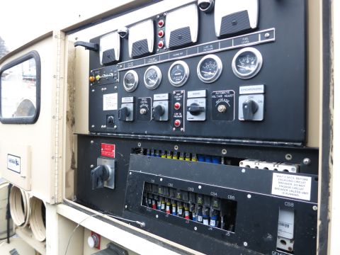 1991 Ford LTD Crown Victoria - Close-up of a control panel multiple gauges, toggle switches, and a circuit breaker box.