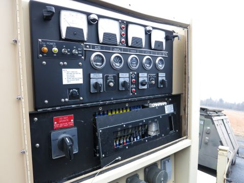 1991 Ford LTD Crown Victoria - Close-up of a generator's control panel, multiple gauges and switches for operation.