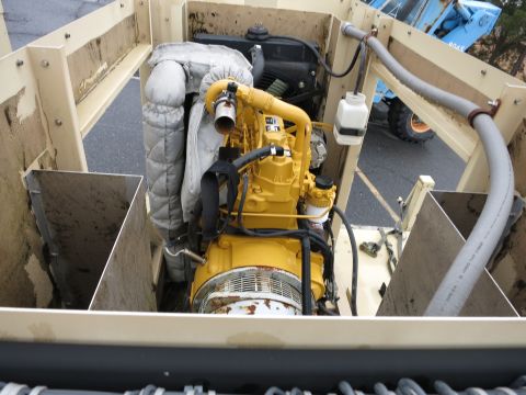 1991 Ford LTD Crown Victoria - Close-up view of a yellow engine assembly, likely part of a generator or industrial equipment.