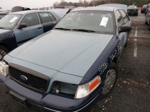 1991 Ford LTD Crown Victoria - This Ford Crown Victoria police car appears to be from the late 1990s, not 1991. It's missing a headlight.