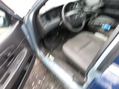 1991 Ford LTD Crown Victoria - The interior of a car is visible with the driver's side door open, showing the dashboard and seats.