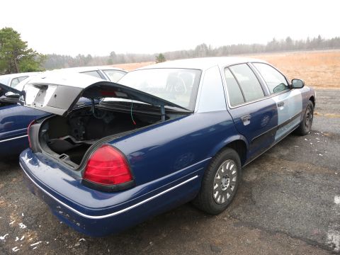 1991 Ford LTD Crown Victoria - A blue and light blue Ford Crown Victoria is parked outside with its trunk open.
