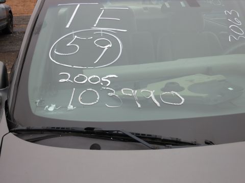 1991 Ford LTD Crown Victoria - Handwritten markings on a car's windshield, including numbers and what appears to be a date.