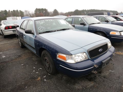 1991 Ford LTD Crown Victoria - Two-tone Ford Crown Victoria in a lot with other vehicles. Text on windshield indicates auction unit number.