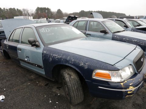 1991 Ford LTD Crown Victoria - Junkyard Ford Crown Victoria shows significant body damage and mismatched paint panels.