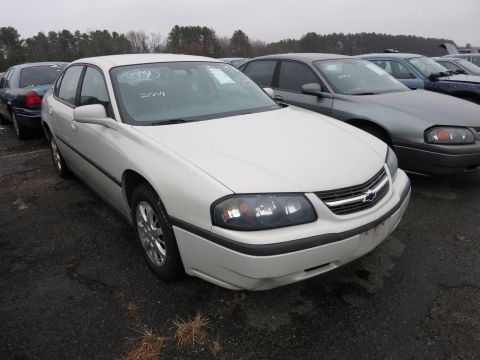 1991 Ford LTD Crown Victoria - A white Chevrolet Impala is parked in a lot with other vehicles, showing its front and side profile.