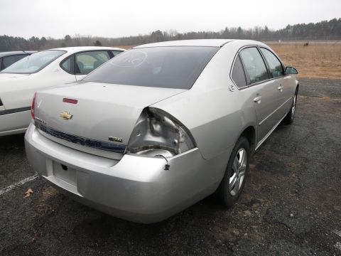 1991 Ford LTD Crown Victoria - Rear view of a silver Chevrolet Impala showing damage to the taillight assembly and a portion of the bumper.