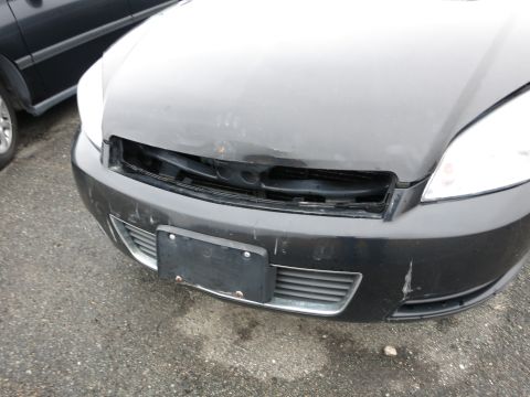 1991 Ford LTD Crown Victoria - Front end of a car showing damage to the grille and bumper area.