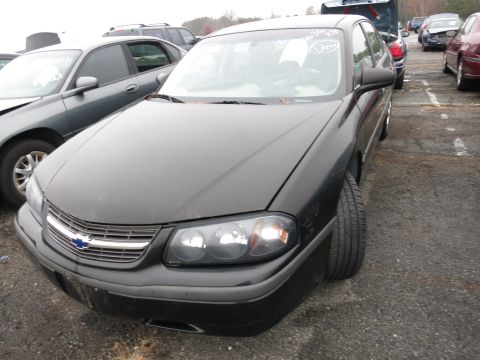 1991 Ford LTD Crown Victoria - Black Chevrolet Impala in a parking lot with other vehicles visible.