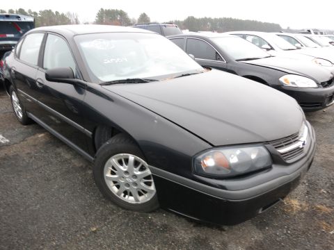 1991 Ford LTD Crown Victoria - A black Chevrolet Impala is parked in a lot with other vehicles. A sticker on the windshield indicates the year 2004.