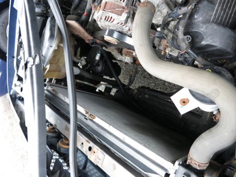 1991 Ford LTD Crown Victoria - A close-up view of a vehicle's engine bay, focusing on the radiator and associated hoses.