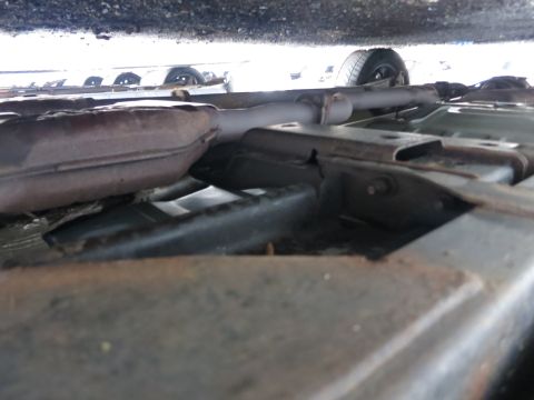 1991 Ford LTD Crown Victoria - Underside view of a vehicle's exhaust system and frame components.