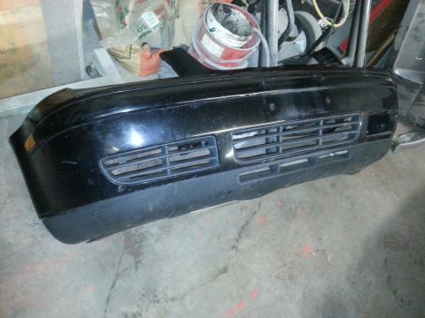 2002 Volkswagen Jetta - A black front bumper is shown in a cluttered garage setting.