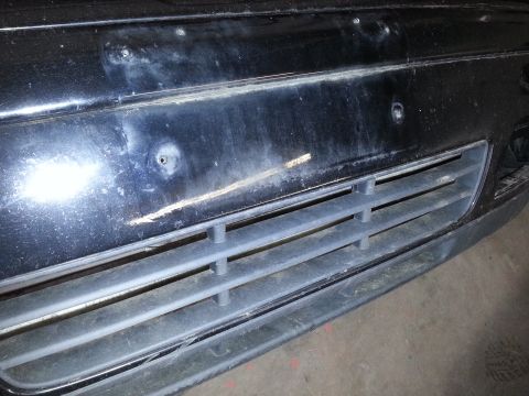 2002 Volkswagen Jetta - Close-up of the front bumper and grille of a 2002 Volkswagen Jetta, showing some wear and tear.