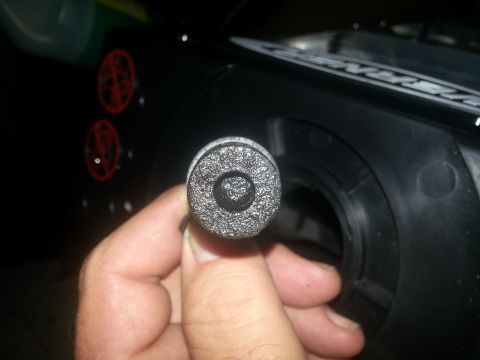 1994 Ford Bronco - Close-up of a textured cylindrical part being held by a hand.