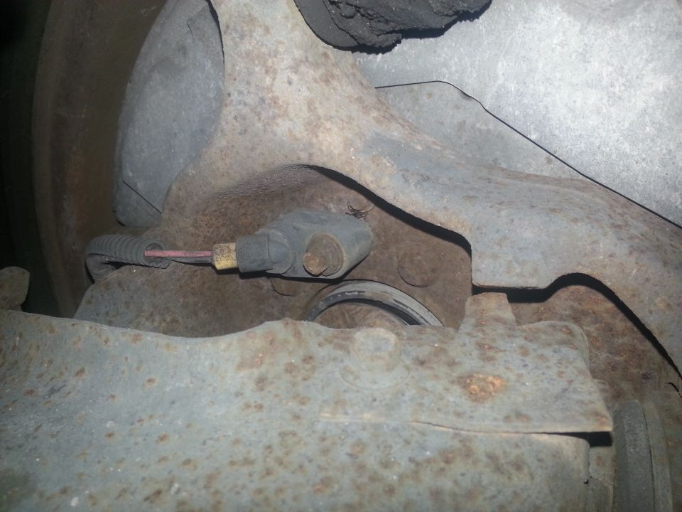 Brake caliper and rotor assembly with sensor wire. Part of a vehicle's suspension